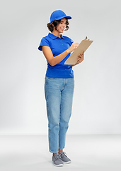 Image showing happy smiling delivery woman with clipboard