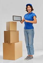 Image showing delivery girl with parcel boxes and tablet pc