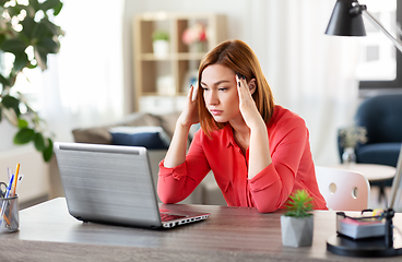 Image showing stressed woman with laptop working at home office