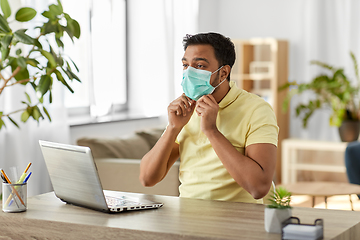 Image showing indian man in mask with laptop at home office