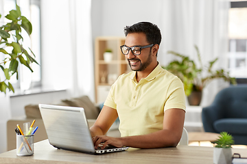 Image showing indian man with laptop working at home office