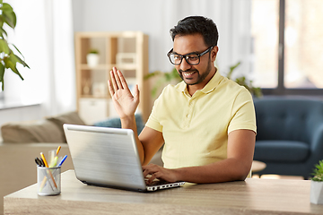 Image showing happy man with laptop having video chat at home