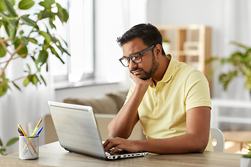 Image showing bored man with laptop working at home office