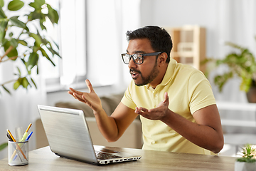 Image showing stressed man with laptop working at home office