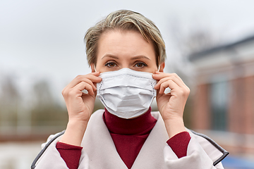 Image showing young woman wearing protective medical mask