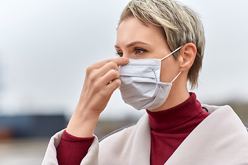 Image showing young woman wearing protective medical mask