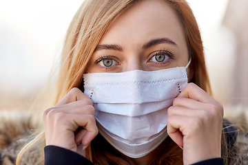 Image showing young woman wearing protective medical mask