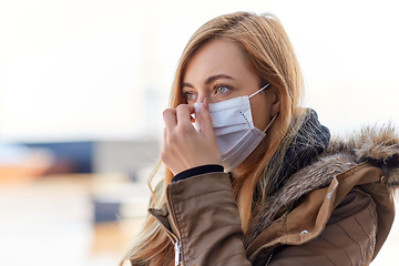 Image showing young woman wearing protective medical mask