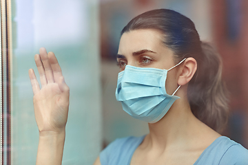 Image showing sick young woman wearing protective medical mask