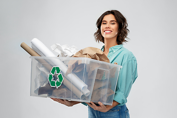 Image showing happy smiling young woman sorting paper waste