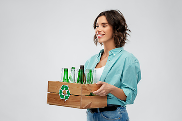 Image showing smiling young woman sorting glass waste