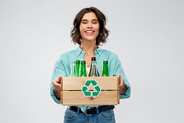 Image showing smiling young woman sorting glass waste