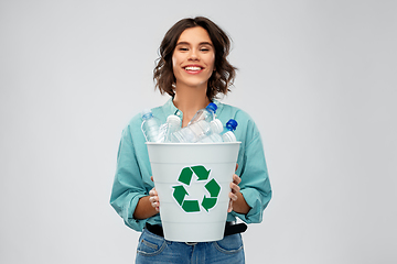 Image showing smiling young woman sorting plastic waste