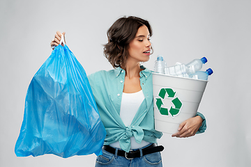 Image showing smiling woman sorting plastic waste and trash bag