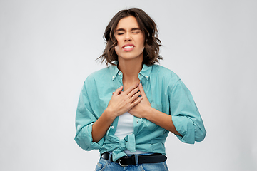 Image showing young woman having heartache or heartburn