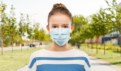 Image showing teenage girl in medical mask over city street