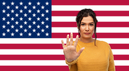 Image showing woman showing stop gesture over flag of america