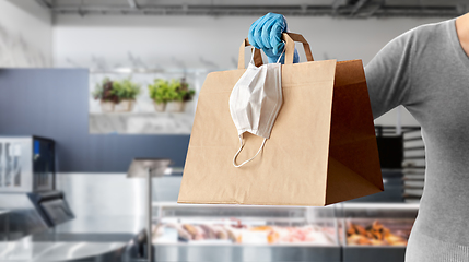 Image showing woman with food in paper bag, face mask and gloves