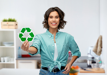 Image showing smiling young woman holding green recycling sign