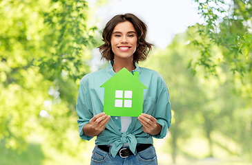 Image showing happy woman with green house on natural background