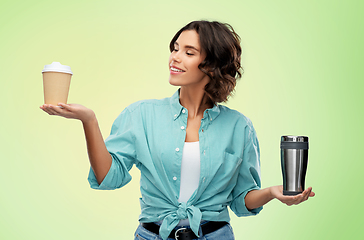 Image showing woman comparing thermo cup and paper coffee cup