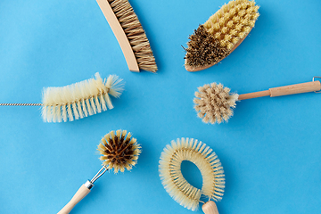 Image showing different cleaning brushes on blue background