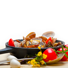 Image showing fresh clams on an iron skillet