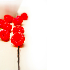 Image showing bunch of fresh raspberry on a bowl and white table