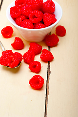 Image showing bunch of fresh raspberry on a bowl and white table