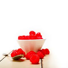 Image showing bunch of fresh raspberry on a bowl and white table