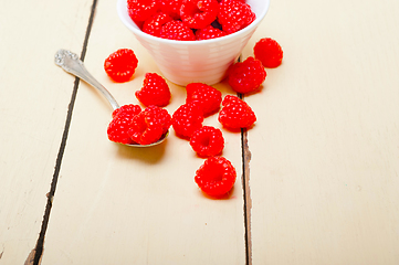 Image showing bunch of fresh raspberry on a bowl and white table