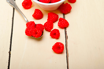 Image showing bunch of fresh raspberry on a bowl and white table