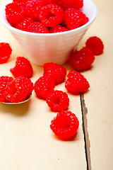 Image showing bunch of fresh raspberry on a bowl and white table