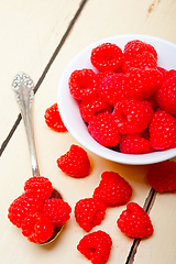 Image showing bunch of fresh raspberry on a bowl and white table