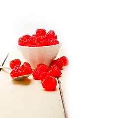 Image showing bunch of fresh raspberry on a bowl and white table