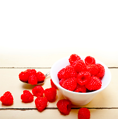 Image showing bunch of fresh raspberry on a bowl and white table