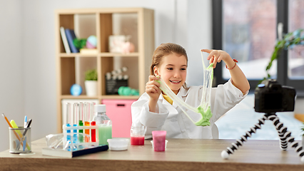 Image showing girl with slime and camera video blogging at home