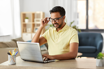 Image showing indian man with laptop working at home office