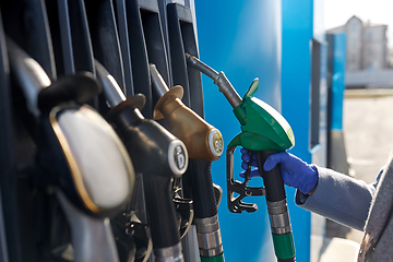 Image showing close up of hand in glove with gas nozzle