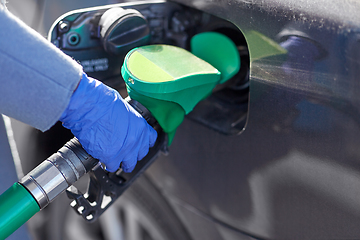 Image showing close up of hand in glove filling car with petrol