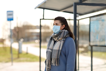 Image showing young woman wearing medical mask at bus stop