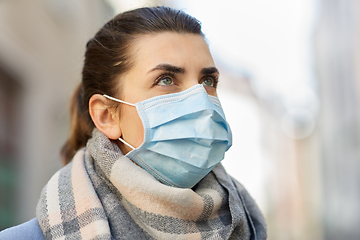 Image showing young woman wearing protective medical mask