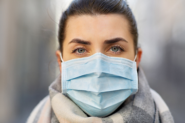 Image showing young woman wearing protective medical mask