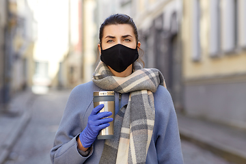 Image showing woman in reusable mask with tumbler in city