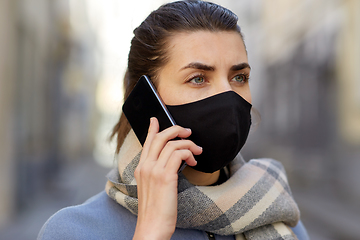 Image showing woman in protective reusable mask calling on phone