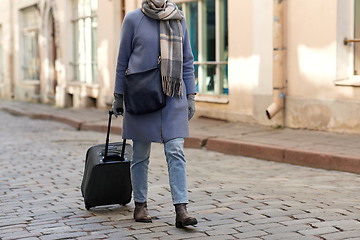 Image showing woman in protective mask with travel bag in city