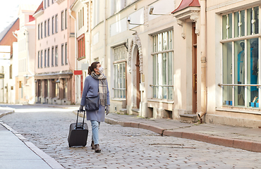 Image showing woman in protective mask with travel bag in city