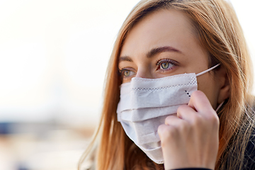 Image showing young woman wearing protective medical mask