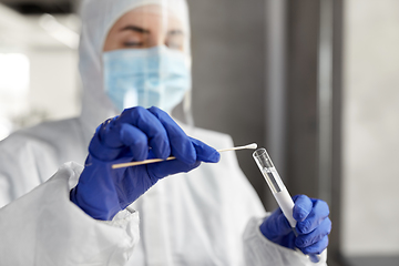 Image showing scientist holding beaker with coronavirus test