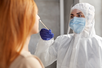 Image showing doctor in protective wear making coronavirus test